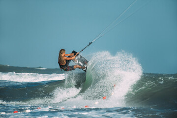 A kite surfer rides the waves