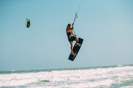 A kite surfer rides the waves