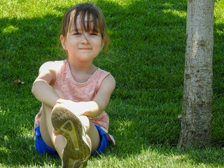 little girl playing on the grass