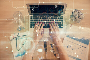 Double exposure of woman hands working on computer and data theme hologram drawing. Top View....