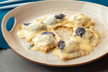 Italian dish ravioli with parmesan in a plate