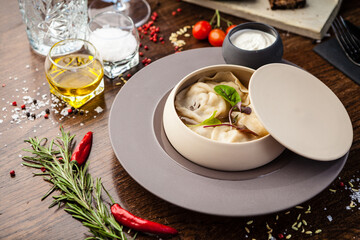 Black Angus beef hand-made dumplings. Cucumber-julienne with chilli-garlic butter and sour cream. Delicious healthy traditional food closeup served for lunch in modern gourmet cuisine restaurant
