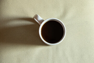 a cup of coffee for breakfast on a light background, a cup of coffee on the table