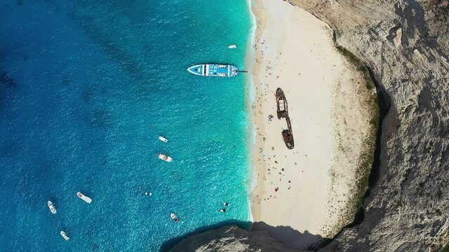 View of Navagio beach, Zakynthos Island, Greece. Blue sea water. Rocks and sea. Summer landscape from the air.