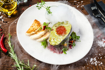 Tuna tartare. Trout roe, avocado cream, marinated onions. Delicious healthy Italian traditional food closeup served for lunch in modern gourmet cuisine restaurant