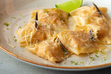 Italian dish ravioli with parmesan in a plate