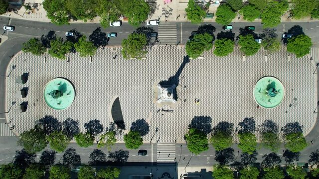 Aerial view above the Statue in the Rossio square in sunny Lisbon - top down, drone shot