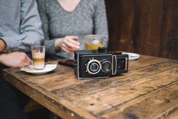 Fototapeta na wymiar Retro video camera on cafe table