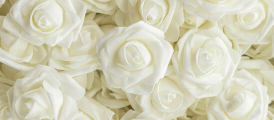 banner with background of white fake flowers. Artificial white foamirane roses.