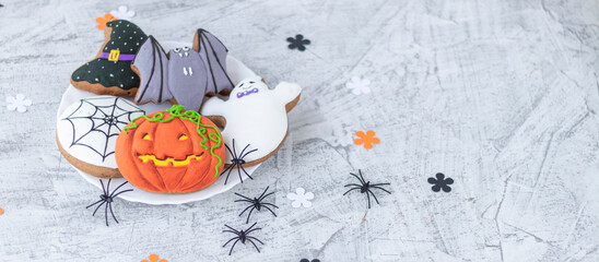 banner with Halloween ginger cookies. Making homemade gingerbread cookies for Halloween. Halloween objects on textured. Funny ginger biscuits.