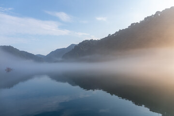 river covered with white fog in sunrise