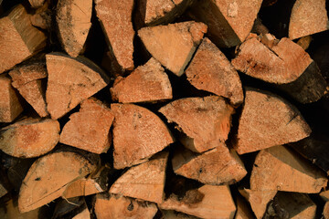 Chopped firewood stacked in rows as background