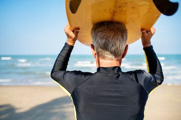 Mature surfer ready to catch a wave