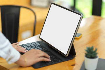 Fototapeta na wymiar Female surfing some business information via tablet, tablet with blank empty screen