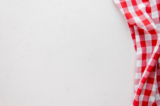 White concrete background with red and white napkin. Copy space