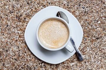 The coffee mug placed on the stone table top