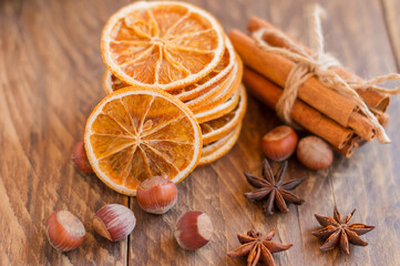 Aromatic cinnamon sticks, dry oranges and anise on wooden table, aromatic ingrediants for mulled wine or christmas baking