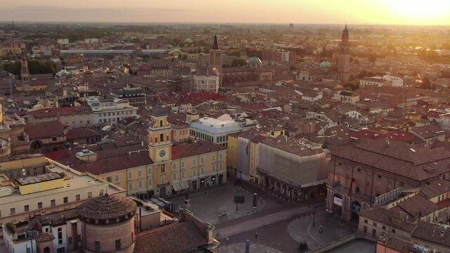 parma city centre aerial view drone flying orbit over garibaldi main square and town hall at sunrise,italian town cityscape at dawn