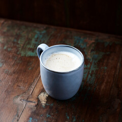 Cappuccino on dark wooden background. Close up. 