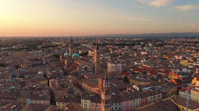 parma aerial view drone flying orbit over city centre cathedral and baptistery,wide shot of italian town cityscape at dawn