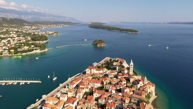 Aerial drone footage of the famous Rab medieval old town by the Adriatic sea in Croatia on a sunny summer day