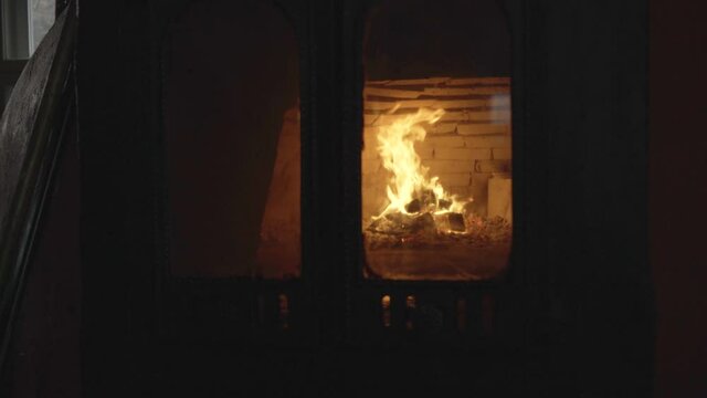 Firewood is burning in a closed wooden stove Horno de Leña. Slow motion