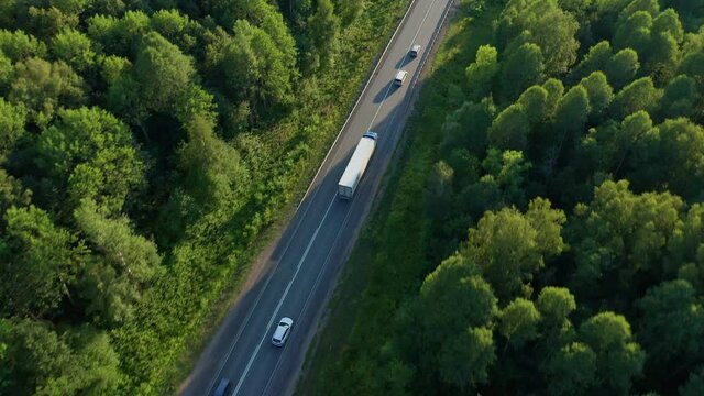 View from above on the road loaded with different modes of transport in the evening. Logistics. Transportation of groupage cargoes, delivery of products to the destination. High quality. 4k footage.