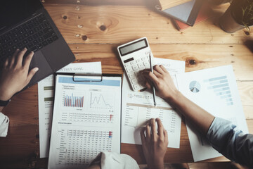 focus hand using calculator, Two young business executives are discussing to change their business...