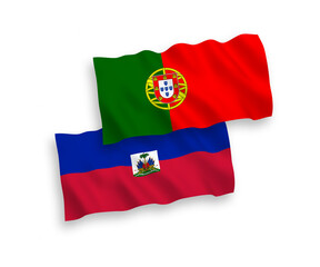 National vector fabric wave flags of Portugal and Republic of Haiti isolated on white background. 1 to 2 proportion.