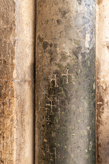 Religious  crosses are carved on a stone column at the entrance to the Church of the Holy Sepulcher in Christian quarters in the old city of Jerusalem, Israel