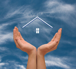 Naklejka premium Woman hand hold a transparent home model on blue sky with clouds, Saving for buy a new house or real estate and loan for plan business investment concept. Real estate concept