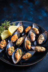 Steamed mussels with herbs and lemon. Tapas plate with mussels. Food photography
