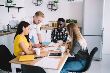 Positive diverse colleagues doing paperwork