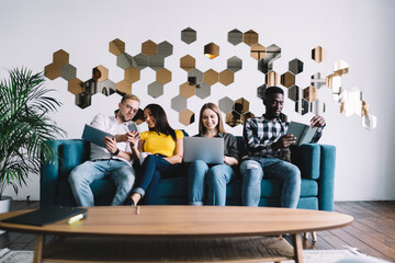 Fototapeta premium Multiethnic people chilling together on couch