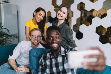 Happy group of friends taking selfie