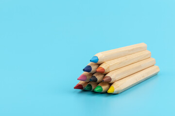 Fototapeta premium Wooden colorful ordinary pencils isolated on blue background
