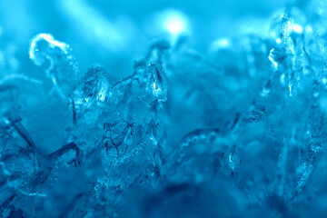 Fototapeta na wymiar Winter theme background with frozen blue ice splashes in it.