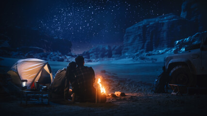 Happy Couple Camping in the Canyon, Sitting Watching Campfire and Starry sky Together, She Rests...