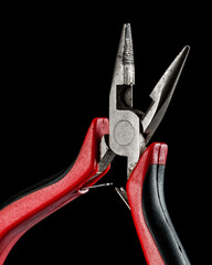 old, used hand tool isolated on black background, close up