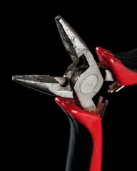 old, used hand tool isolated on black background, close up