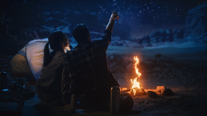 Happy Couple Nature Camping in the Canyon, Sitting by Campfire Watching Night Sky with Milky Way...
