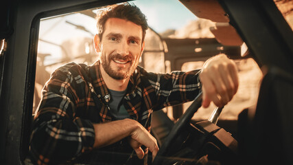Desert Road Trip: Portrait of Handsome Male Explorer Looking out of Car Driver Window and Smiling....
