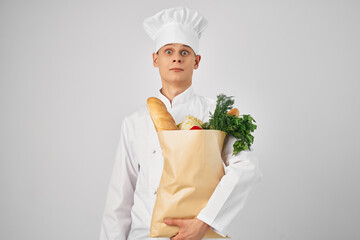 a man in a chef's uniform a package with products restaurant work