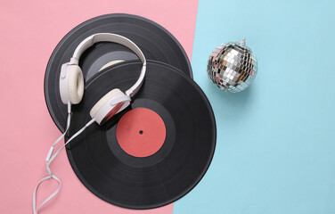 Fototapeta na wymiar Retro vinyl records with Disco ball and headphones on blue pink background. Minimalism party concept