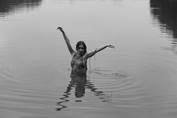 Woman in dress in the lake in black and white