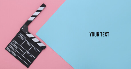Movie clapper board on a blue-pink pastel background. Filmmaking, Movie production, Entertainment...