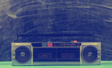 80s Retro old school portable stereo radio cassette recorder on the background of blackboard