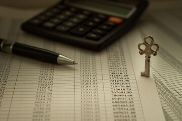 pen and calculator on financial newspaper