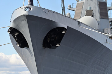 The bow of a warship. Black anchors stick out from both sides