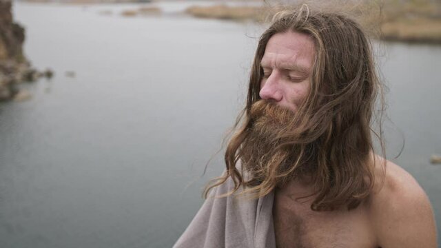 Bearded man meditates on nature